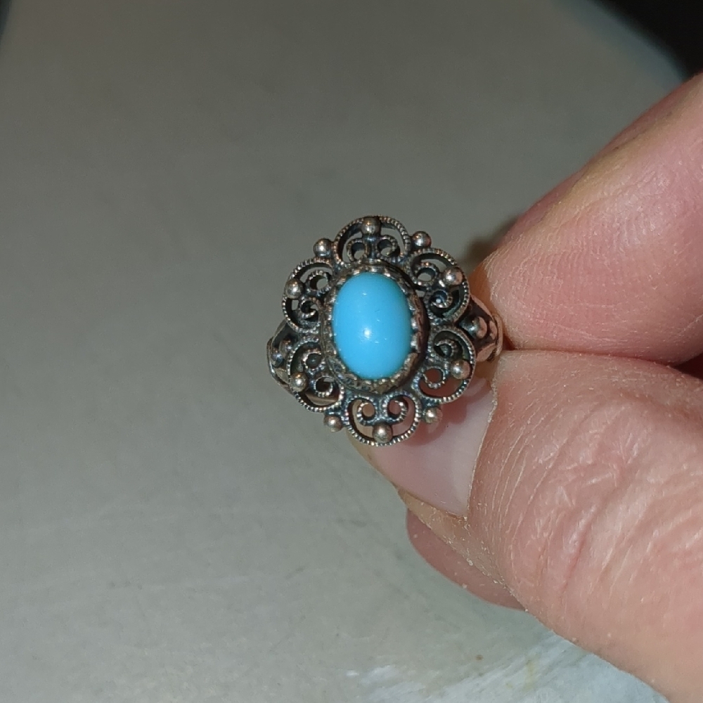 Sterling Silver Adjustable Band With Turquoise Colored Stone.